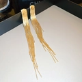 Detailed view of long gold tassel earrings with metallic texture on a tray - Gold Long Tassel (13#) / Gold