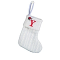 Detail of white cable knit Christmas stocking featuring a red embroidered letter Y and mini hat - Letter Y