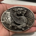 Detailed close-up of antique silver dragon belt buckle with intricate metal carving - Piqiu Dragon