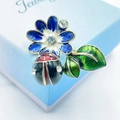 Vibrant enamel ladybug on blue flower brooch with sparkling crystal leaf details - Blue Flower Green Leaf Ladybug Combo