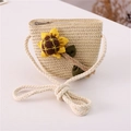 Detailed view of kids' straw crossbody bag with sunflower doll and cotton rope strap - Sunflower / Beige