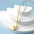 Chic gold-finished bubble heart pendant necklace displayed on a minimalist tiered stand - Letter V(V)