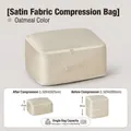 Oatmeal satin quilt storage bag with side handle showing 50cm to 25cm compression - Down Compression Storage Bag - Large Beige