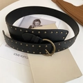 Detail view of the black leather waist belt with double-row bronze rivets and vintage round buckle - Black