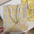 Flat lay of a large floral cotton canvas tote bag with dense yellow and pink flower patterns - T-7 Yellow Floral with Mini Bunny