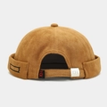 Close-up of camel brimless docker hat with adjustable strap and geometric embroidery - Adjustable / Caramel color