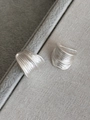 Macro view showing brushed matte silver C-shaped earrings with textured wavy surface - S925 Silver Pin / Silver