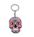 Macro detail of pink sugar skull acrylic keychain with floral patterns and gold accents - Style I