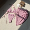 Macro detail of pink textured fabric three-piece bikini set with matching beach skirt - S / Pink