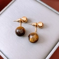 Macro shot of tiger eye stone pendant earrings with 18k gold plating in a gray jewelry box - Gold/Brown (Silver Pin)