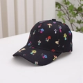 Close-up of black kids baseball cap featuring colorful bear and mushroom cartoon prints - Kids One Size / Black