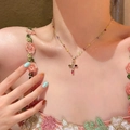 Colorful gemstone cross necklace with gold chain and rainbow beads on a model - Resort Style Cross Beaded (X2021) / Gold/Colorful Stone