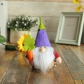 Plush gnome variant featuring a purple felt hat and holding an orange carrot ornament - Purple Hat Sweet Potato