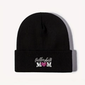 Close-up of Volleyball MOM heart embroidery on a black ribbed knit beanie hat - One Size / Black