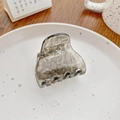 Translucent smoke grey acetate hair claw clip with glitter finish on a ceramic plate - Starry Grey