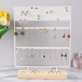 Detail view of white iron jewelry rack with earrings holes and wooden base organizer - 144 Holes Large Upgrade / White