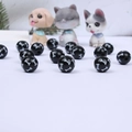 Close-up of black round wooden beads with white bone patterns for DIY pet jewelry - Black Base White Bone