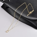 Minimalist 18K gold chain necklace featuring a teardrop-shaped crystal pendant on leather - 18K Gold Water Drop