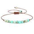 Detailed macro view of 4mm green stone beads and adjustable woven cord on the bracelet - Green Imperial Stone/FD8441