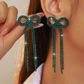 Green rhinestone bow tassel earrings in copper, worn by model for elegant style - Stud Earrings / Green