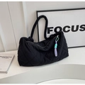 Detail of black quilted puffer tote bag featuring a bicolor purple and mint green charm - Black