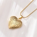 Detailed close-up of golden heart locket necklace with vintage floral engraving - Vintage Floral Carving