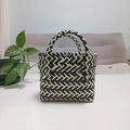 Close-up of a woven basket bag showing black and white twill pattern and scalloped edges - Mini Black Contrast