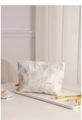 Detail view of canvas makeup bag with blue floral patterns on a white tray - Light Blue