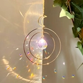 Golden moon and sun catcher with crystal prism casting rainbow reflections on white wall - B11 Style