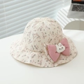 Close-up of floral baby sun hat with large pink bow and cute strawberry rabbit doll - 50cm (1-3 Years) / Pink Floral