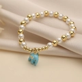 Beaded pearl bracelet with golden beads and a light blue enamel elephant pendant - Blue Elephant Pattern