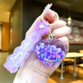 Detail of purple heart liquid keychain with flower sequins and Fairy Tales strap - Purple Bow With Glowing Bubble Beads And Heart