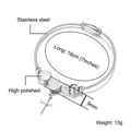 Detail of polished stainless steel bangle with cross pendant and heart charm details - Steel