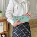 Detail of mint green corduroy pouch featuring an embroidered smiley face and zipper closure - Grass Green Smiley (Small)