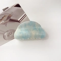 Detail of blue and white marble acetate hair claw with subtle golden glitter texture - 8cm Round Head / Starry Blue