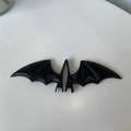 Detailed view of black bat wing hair clips made of textured faux leather for Halloween - Black