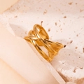 Gold open star ring with hollowed design and cubic zirconia on beige stone base - Intertwined Wave