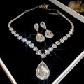 Macro shot of silver zircon flower necklace and teardrop earrings in a gift box - Silver