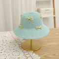 Detail of mint green straw sun hat with yellow lace bows on a golden display stand - Blue Hat