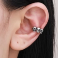 Gothic silver metal ear cuff featuring three detailed skulls design for women - Antique Silver (X216)