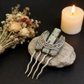 Detail of moon hair comb with raw labradore stones and silver wire on stone background - Labradorite