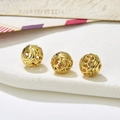 Macro shot of three vintage hollowed-out golden beads for DIY jewelry making - Style 25