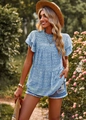 Detailed view of floral blue top with ruffle sleeves and mock neck on model - S / Blue