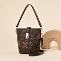 Brown bucket bag with letter print patterns and top handle in a minimalist studio setting - Letter Coffee