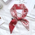 Detail of red and white floral silk twilly scarf with line art on textured white background - Sketch Spring Letter U