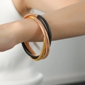 Three-piece stackable spiral metal bangles in gold, black, and rose gold finishes - Gold Black Rose Gold Mixed Thin