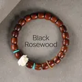 Black Rosewood beaded bracelet with white lotus charm and turquoise accents on grey felt - 8mm Straight Cut Lotus With Ring