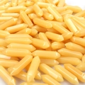 Close-up of yellow hexagonal double-pointed crystal pillars made of smooth resin - Yellow Jade
