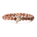 Detail of red-brown and cream beads on elastic bracelet with white dolphin pendant - Red Network Stone