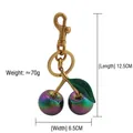 Iridescent cherry keychain bag charm in golden alloy with green leaves and purple gradient - Colorful Cherry with Bronze Green Leaf